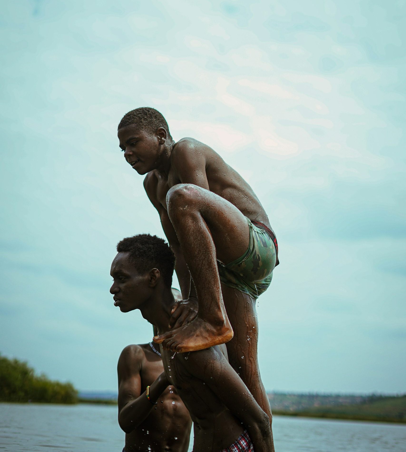 Two young men bathing in a river, embracing the moment